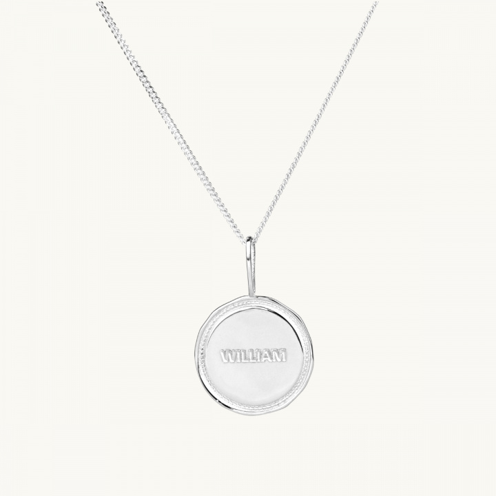 Ett namnmynt med en segerkrans i sterlingsilver